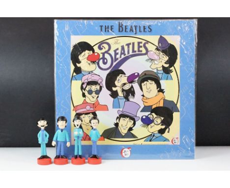 A set of four cast resin The Beatles ornamental figures together with a Rocky Toons Beatles print. 