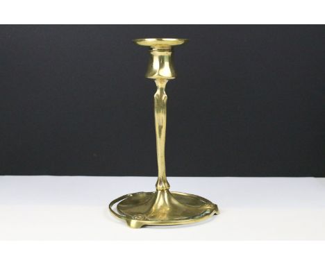 A brass Art nouveau candlestick of classical form 