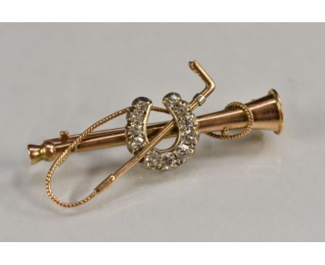 A diamond mounted Hunting brooch, crossed hunting horn and riding crop body, centred with an eleven stone graduated diamond h