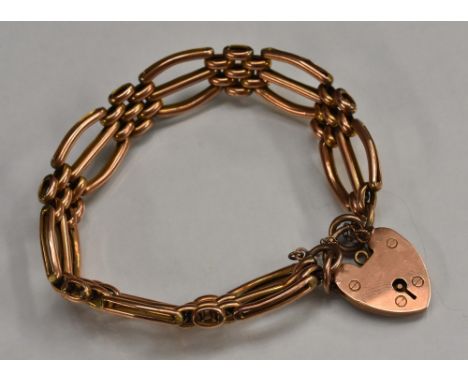 A 9ct rose gold fancy arched triple row gate-link bracelet, padlock clasp, stamped 9ct gold, 13g, cased