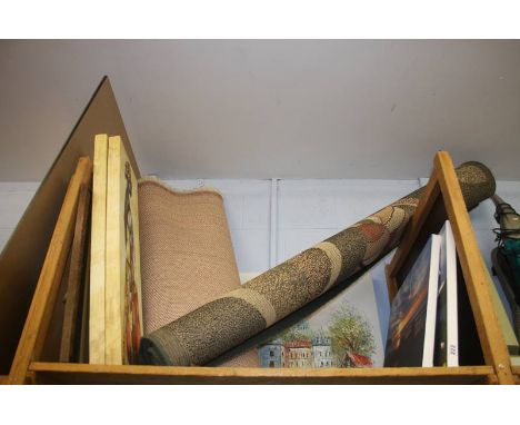 A shelf of canvas prints and rugs