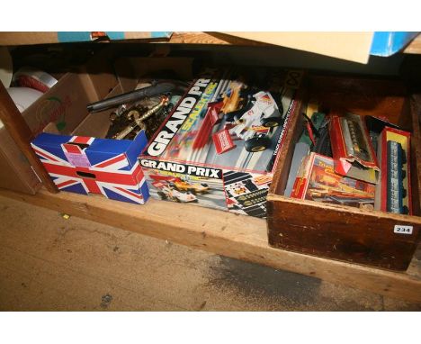 A shelf of miscellaneous, including Scalextric set and Triang railways