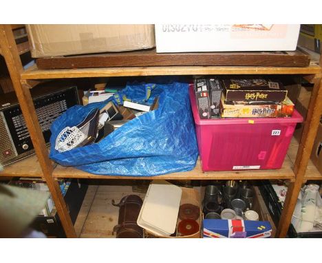 A shelf of miscellaneous , including picture frames and puzzles