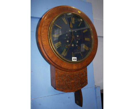 An oak wall clock with painted dial