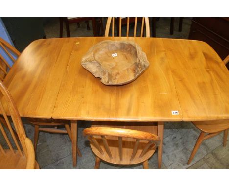 An Ercol drop leaf table and six Ercol hoop back chairs