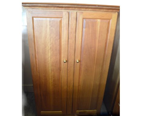 A pair of light coloured wardrobes