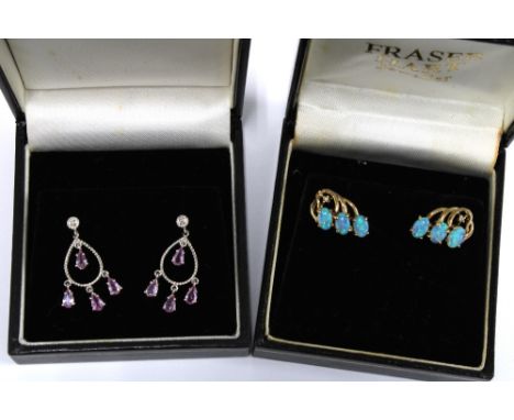 A pair of opal earrings set in 9ct gold together with a pair of 9ct white gold gemset earrings (2) 