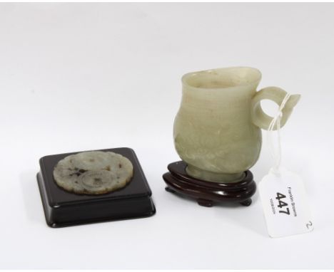 Jade cup with incised lotus pattern, with hardwood stand, 10cm overall together with a hardwood plaque with a pierced jade in
