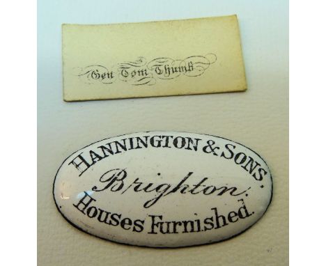A 19th century oval enamel Plaque inscribed "Hannington & Sons, Brighton, Houses Furnished", 1 1/2" (3cms) long, and a miniat