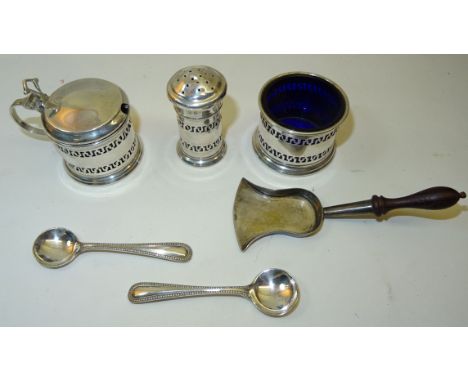 A silver spade shape Caddy Spoon with turned wooden handle, Sheffield 1926, and a three piece silver circular Condiment Set.