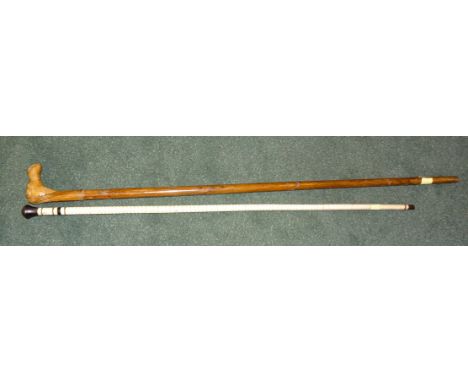 A marine vertebrae Walking Stick with knop handle, 33" (84cms) long, and another Walking Stick with carved camel head handle.