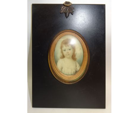 A 19th Century head and shoulders miniature oval Portrait of a child on an ivory panel and in ebonised frame. 