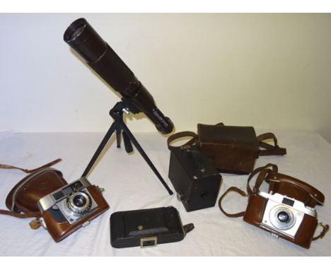 A Swallow Zoom Telescope on tripod stand, Brownie Box Camera, and three others.