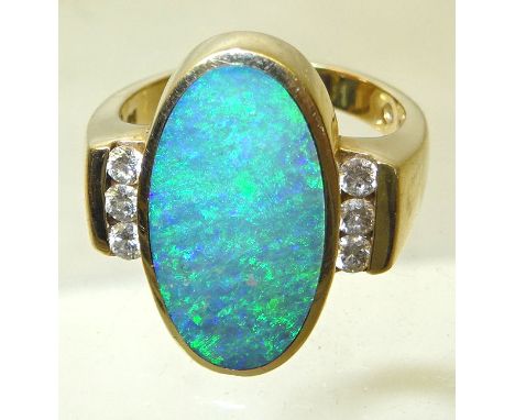 A Kabana 14ct gold Ring set with a large oval opal, the shoulders set with six diamonds.