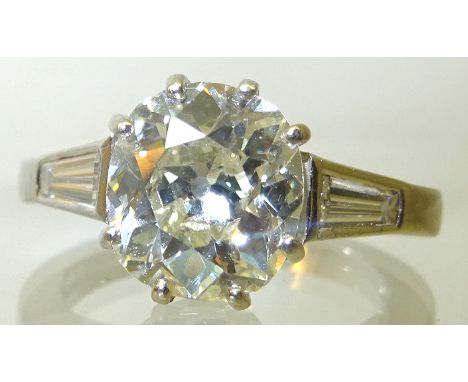 A platinum Solitaire Diamond Ring with a single round old cut diamond measuring approximately 2.67 carats, K SI1, claw set, t