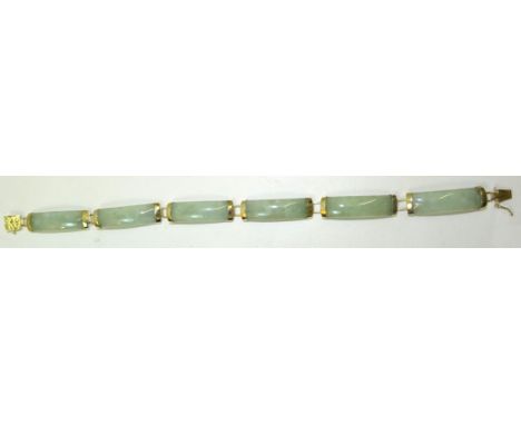 A 9ct gold Bracelet set with six jade oblong panels.