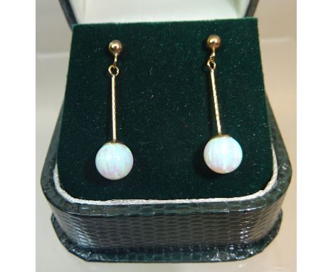A pair of 9ct gold Pendant Earrings, each set with a single opal.