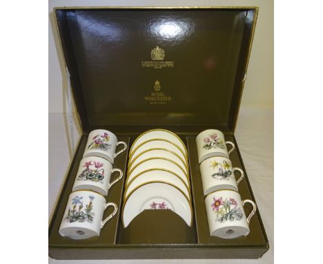 A set of six Royal Worcester Coffee Cans and Saucers decorated with flowers and in presentation box.