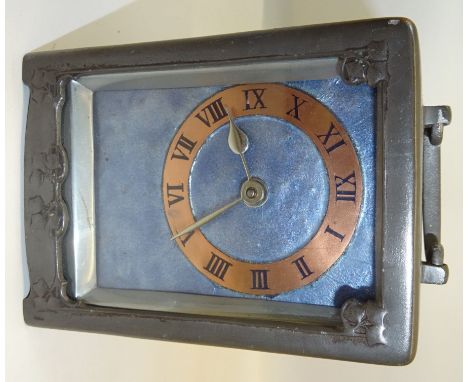 A Liberty & Co pewter Carriage Clock by Archibald Knox numbered 0721 with a copper and blue enamel dial with Arts and Crafts 