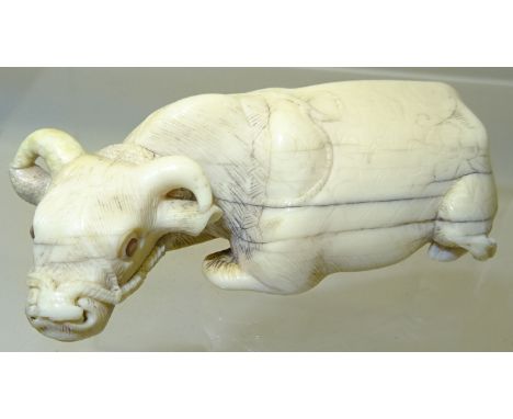 A Japanese Netsuke in the form of a carved ivory water buffalo.  2 1/2" (6 1/2cms) long. 