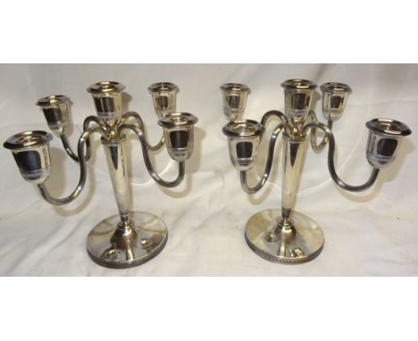 A pair of Continental five light Candelabra with scroll branches and circular bases, 9 1/2" (24cms) high, 39.6 oz.