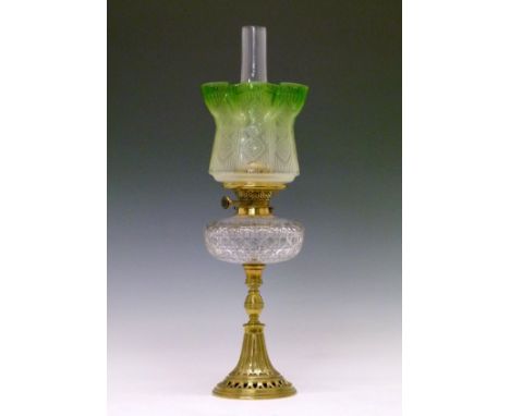 Late 19th/early 20th Century oil lamp having a clear cut glass reservoir, cast brass base having a pierced circular foot, gre