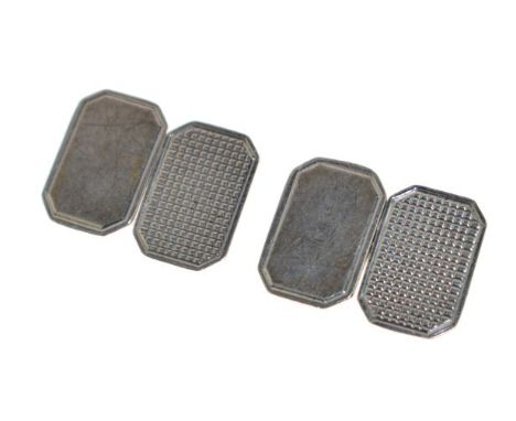 Pair of silver cufflinks by Cohen & Charles, Birmingham 1969, one engine turned and one plain panel with chain connectors, in