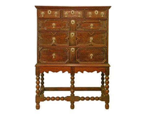 Jacobean style oak chest on stand fitted three short and three long drawers having brass handles and escutcheons and typical 