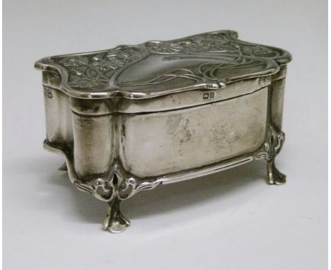 Edward VII silver trinket box having embossed stylised foliate decoration and standing on four pierced scroll feet, maker Hen