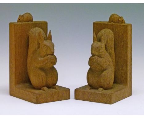 Robert 'Mouseman' Thompson of Kilburn - A pair of oak figural bookends, each decorated with a squirrel clutching an acorn, ty