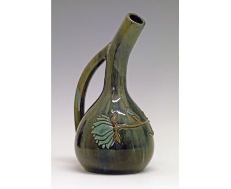 Elton Ware pottery ewer having a slender neck and loop handle, typical stylised foliate decoration in relief on a blue and gr