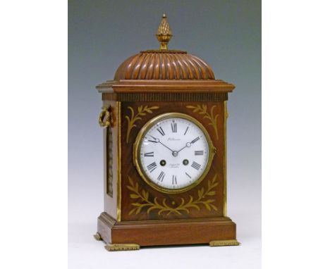 Early 20th Century Regency style brass inlaid mahogany mantel clock having a pineapple finial, carrying handles and grilles t