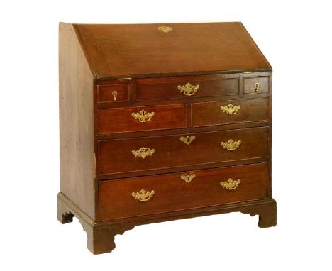 George III oak bureau, the fall flap opening to reveal a fitted stepped interior with well, central cupboard, drawers and pig