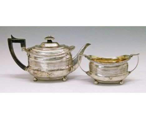 George III silver teapot and two handled sugar basin, each piece having a gadrooned rim, horizontal reeded decoration and sta