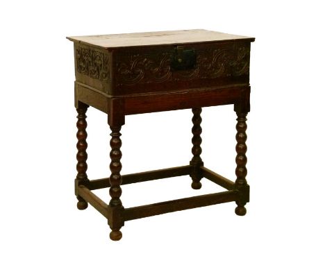 Antique carved oak Bible box on stand having carved scroll decoration, the stand on bobbin turned supports united by stretche