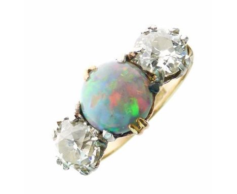 Black opal and diamond three stone ring, stamped '18ct', the circular cabochon 8.2mm diameter x 5mm deep, flanked either side