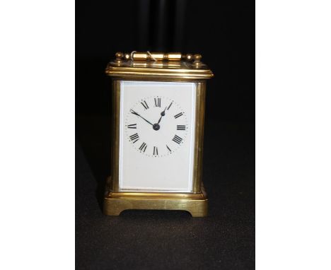 Gilt brass Carriage Clock, with a white enamel dial and Roman hours