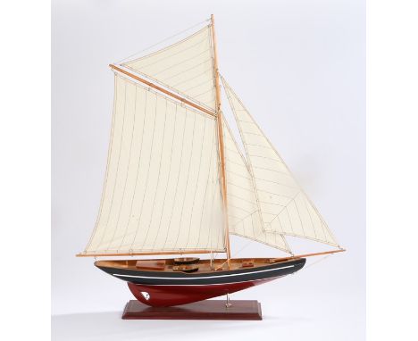 Model of a yacht, with a blue and wood hull, sails raised, 75cm long
