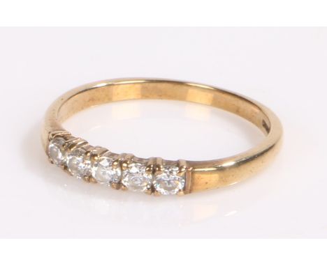 9 carat gold ring the band set with five cubic zirconia, ring size M 1/2