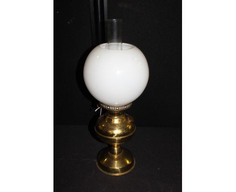 Simple brass oil lamp, with white glass shade, brass reservoir and foot, 49cm high