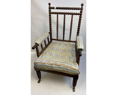 19th century Bobbin-turned armchair, raised on corresponding turned legs ending in castor feet 
