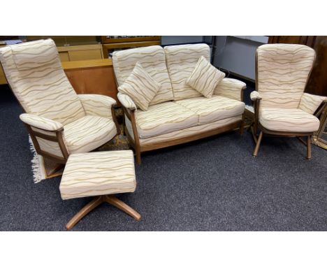 An Ercol Windsor three piece sofa, Two seat sofa, Single spindle back arm chair and single relaxer swivel arm chair. Also com