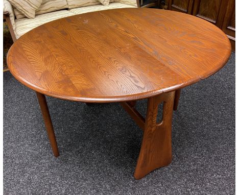 An Ercol elm wood drop end table. [73x120x106cm] 