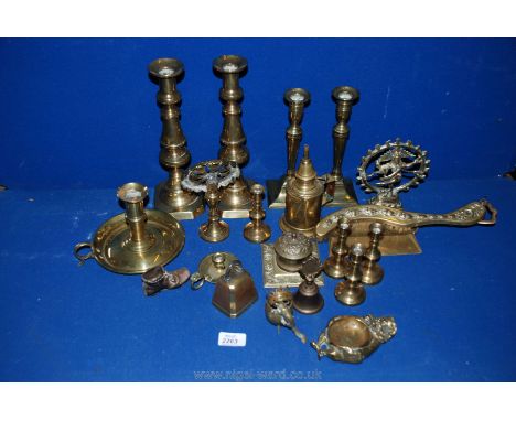 A box of brass including miniature and larger pairs of Victorian candlesticks, chamber stick, taper holder, Pierrot etc.