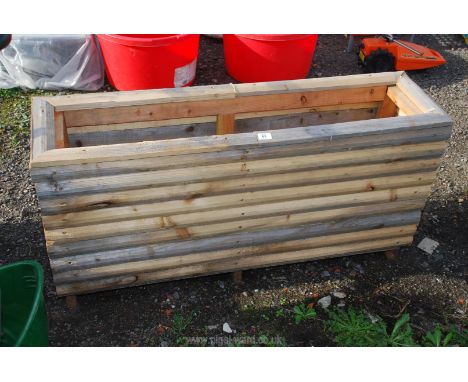 A homemade garden planter 47" x 13" x 24".