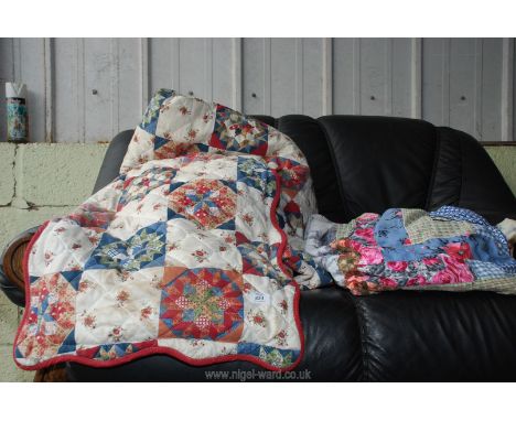 A quilted bed spread and pillow shams plus one other.