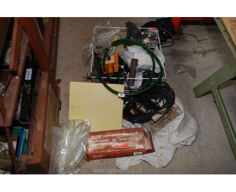 A tile cutter and extension leads in a crate etc.
