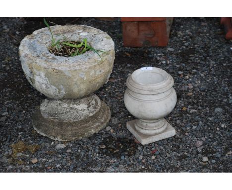 A small marble urn and concrete planter/base.