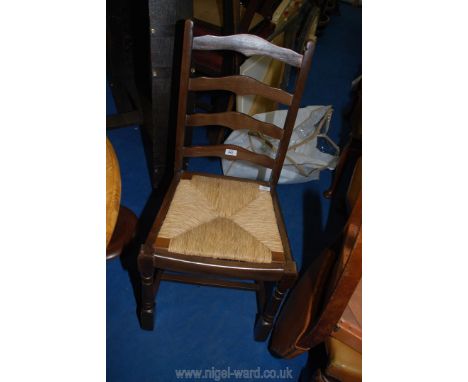 A seagrass seated ladder back chair.
