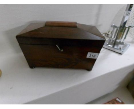 A mahogany tea caddy with key